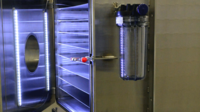 Vacuum drying chamber with adjustable shelves and internal LED lighting, angled view